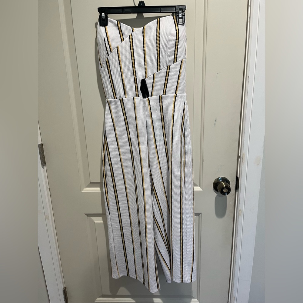 White jumpsuit with yellow/black stripes with cut out in the middle